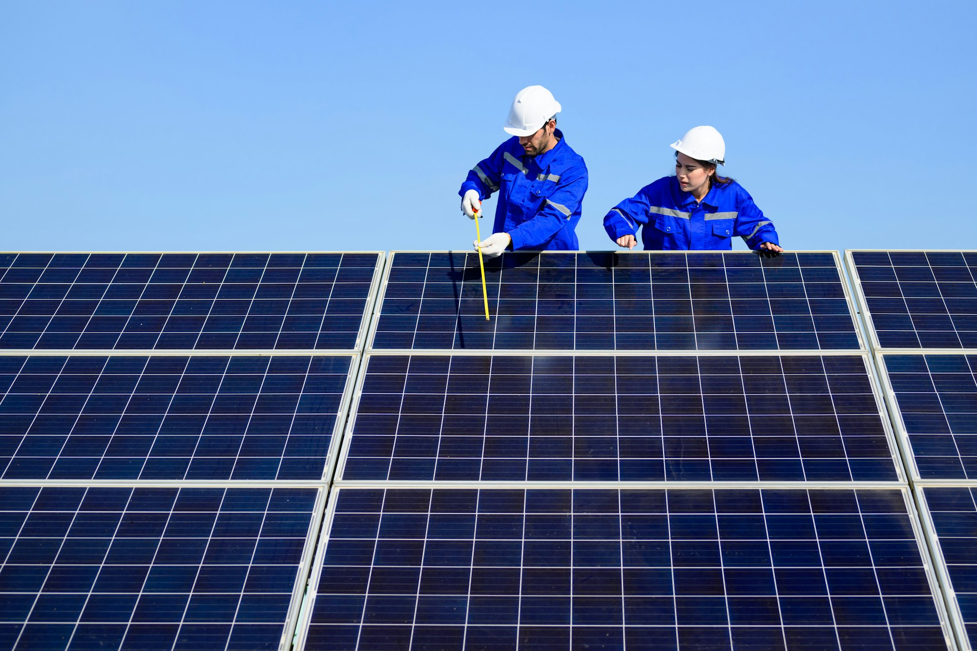 Solar panel station, Engineer installing solar panel at solar energy farm field